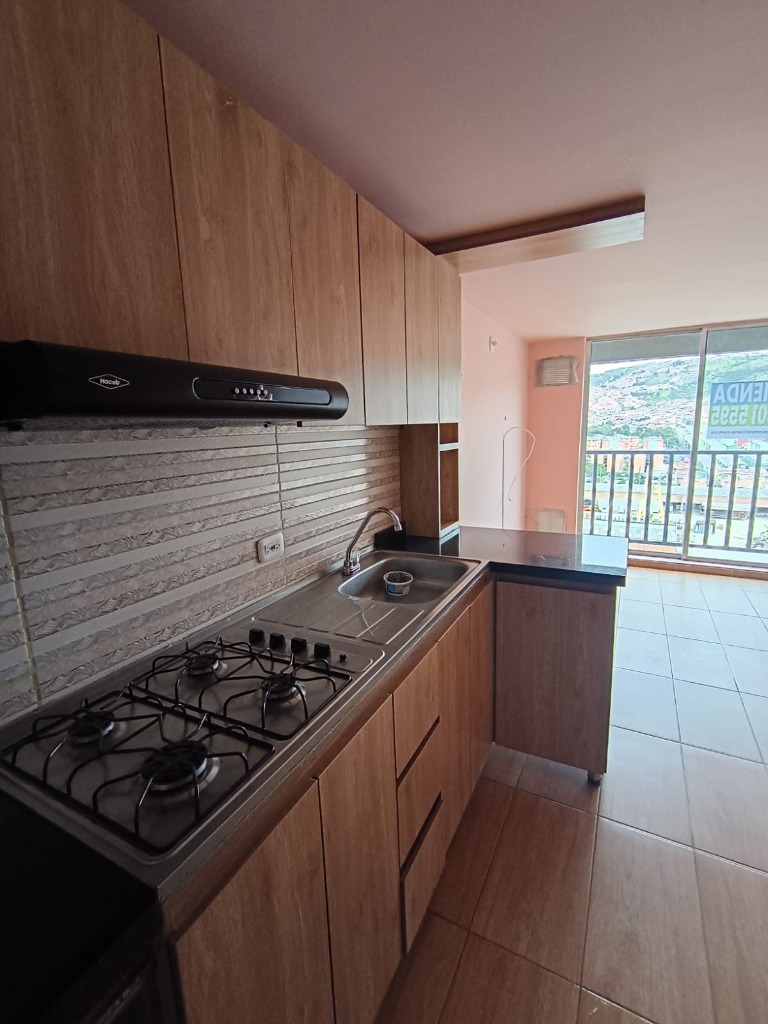 Cocina integral con mesón en granito negro, estufa Haceb y campana El Perdomo